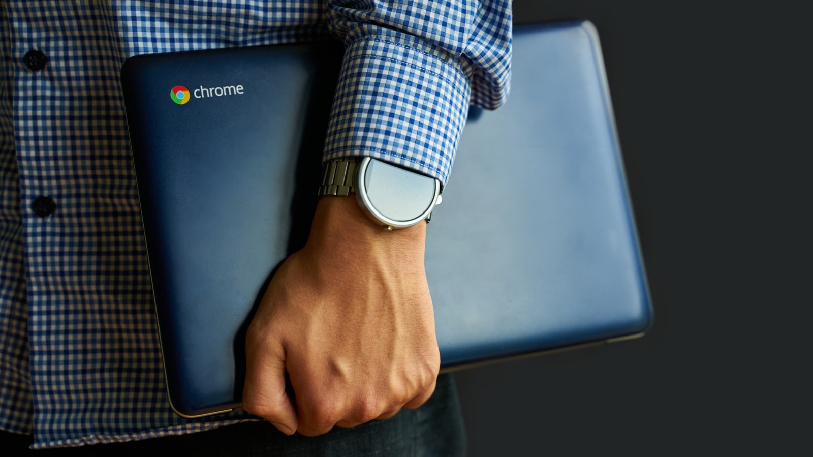 A sleek Chromebook laptop open on a desk in an office environment