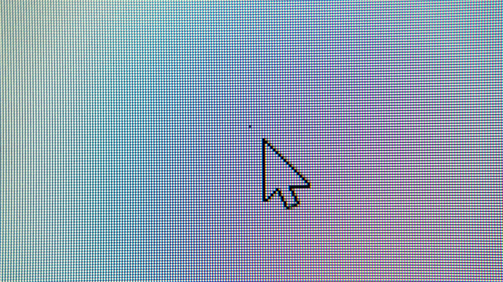 Close-up of a computer monitor showing a single defective pixel