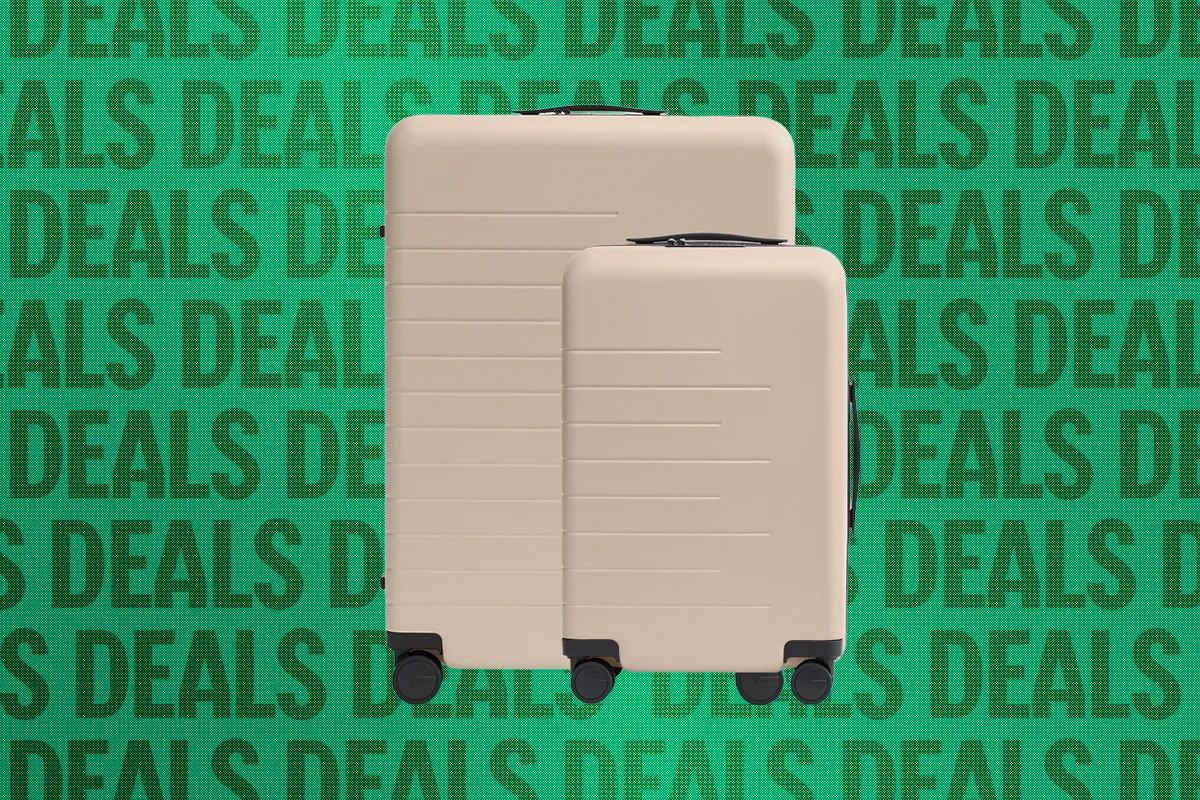 A minimalist Quince suitcase standing in a modern travel setting.